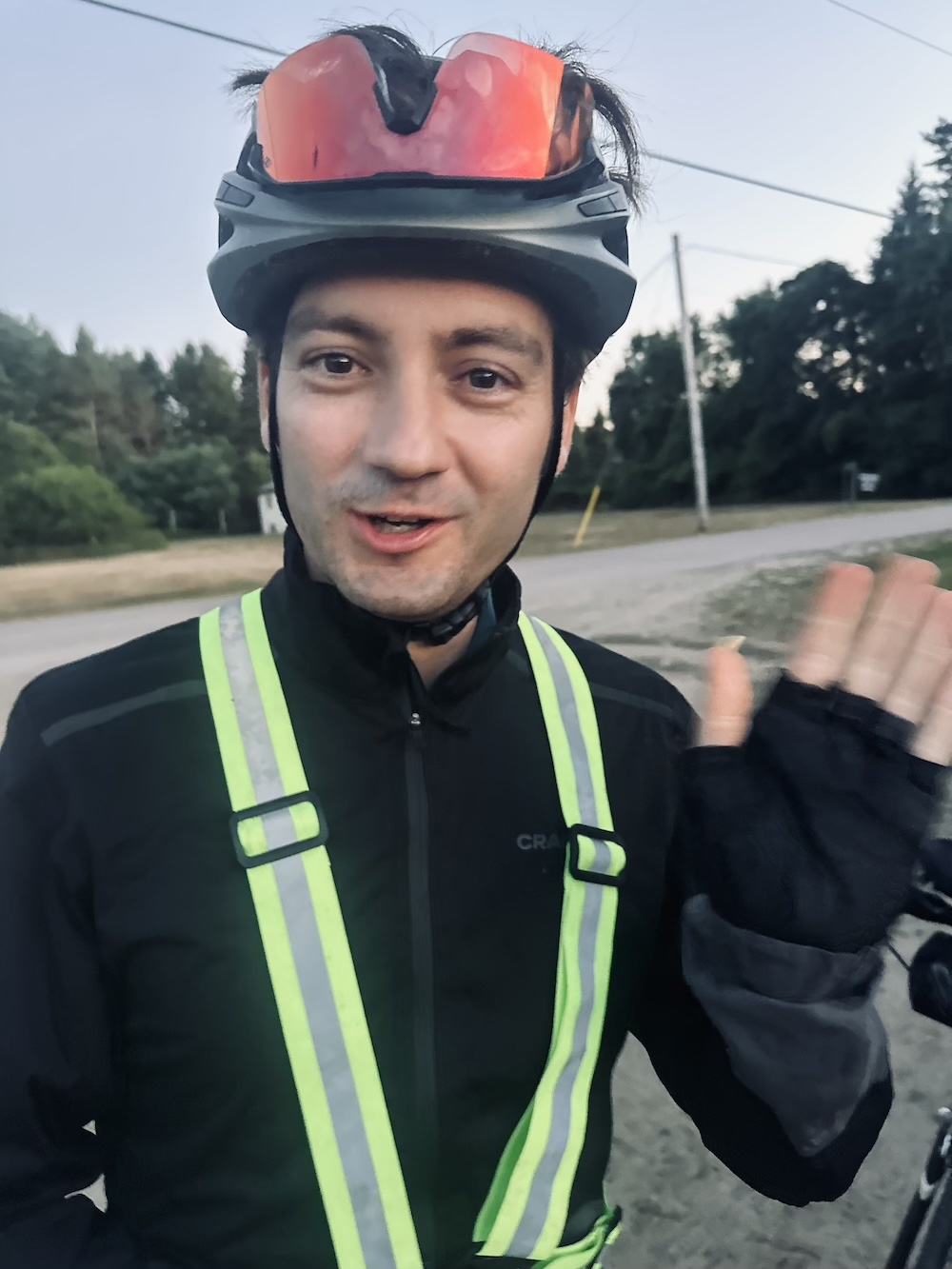Phil in cycling kit waving.