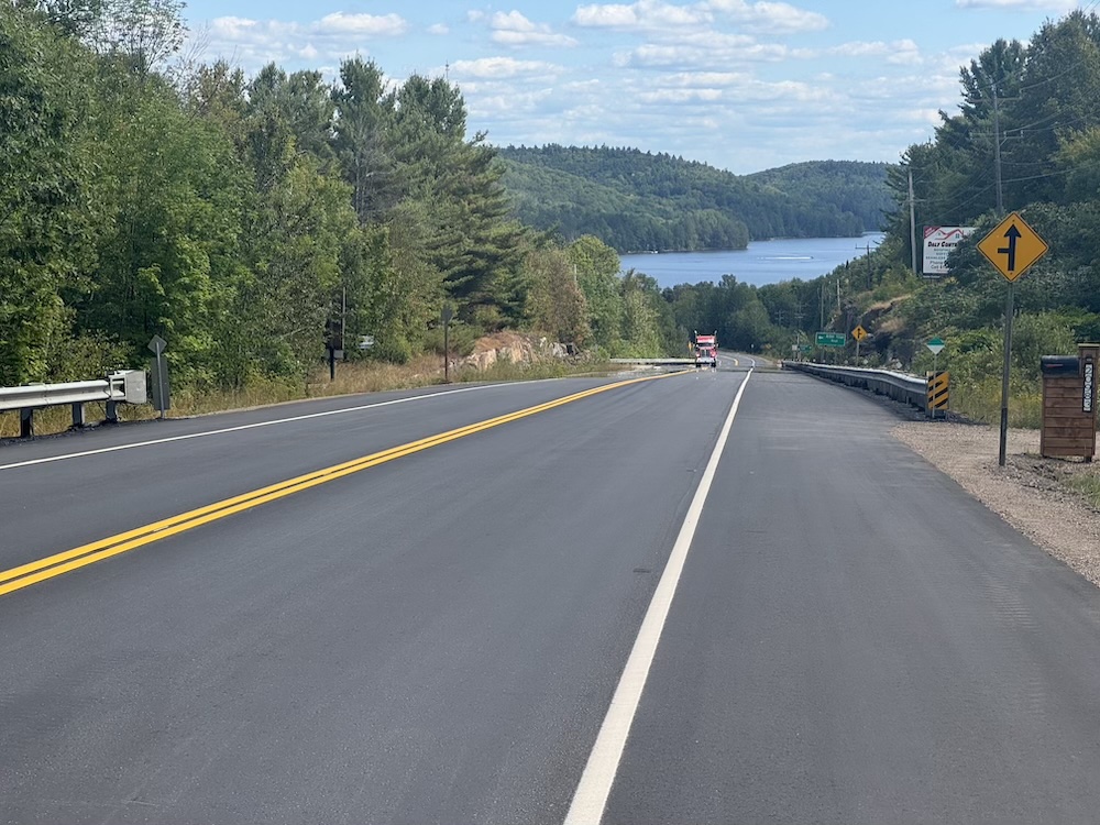 A large downhill view towards a lake at the bottom of a valley in the Canadian shield.