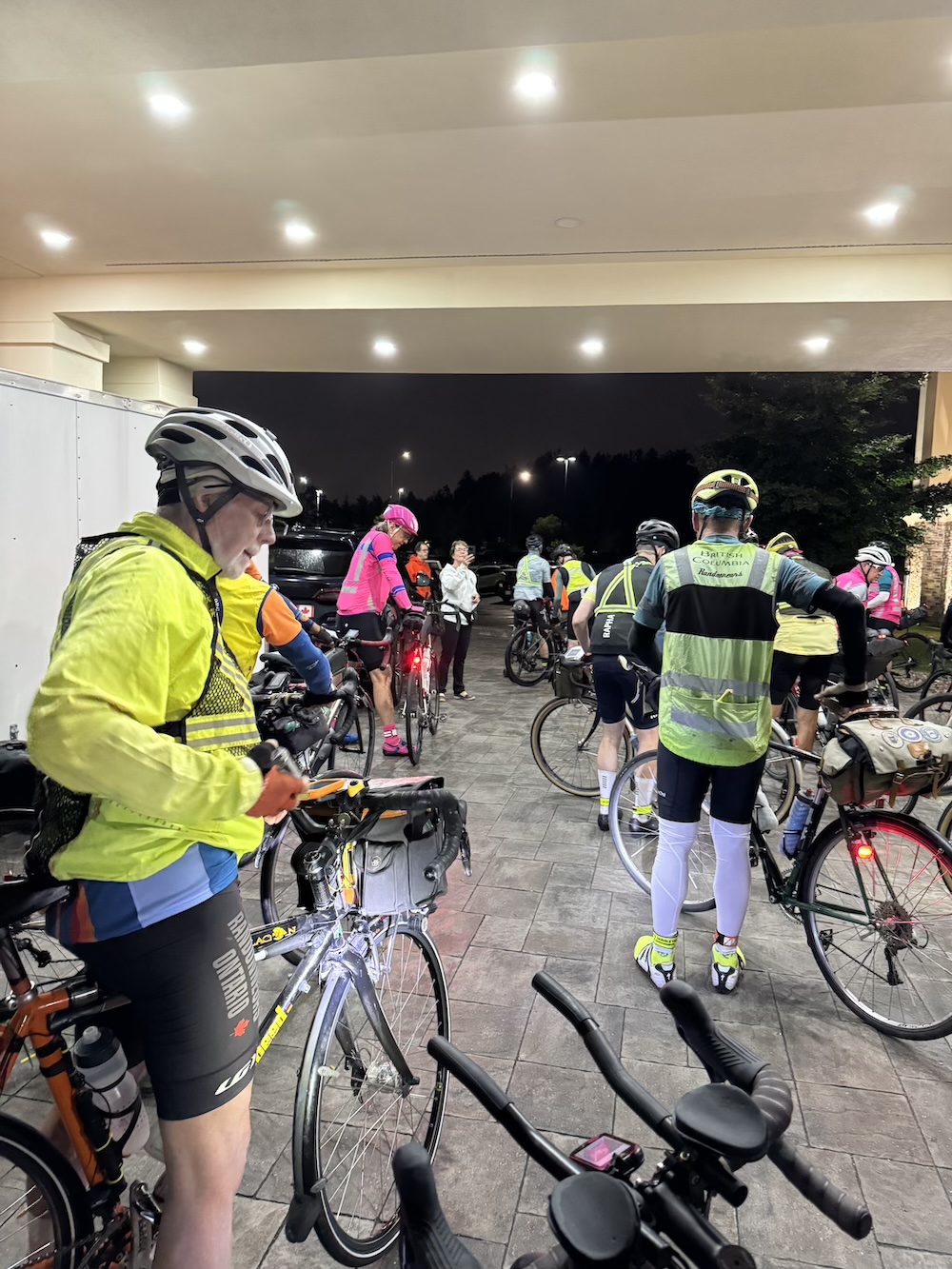 A group of cyclists leaving a hotel lobby